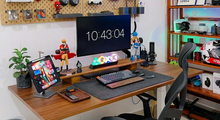 a desk with a computer and a laptop on it