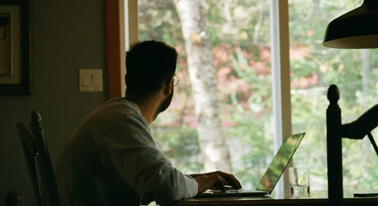 man in gray hoodie using laptop computer