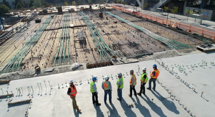 seven construction workers standing on white field